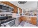 Modern kitchen with stainless steel appliances, granite countertops, and ample cabinet space for storage at 6422 Auburn Ave, Bradenton, FL 34207