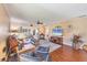 Bright and inviting living room boasts hardwood floors, comfortable seating, and seamless access to other rooms at 6422 Auburn Ave, Bradenton, FL 34207
