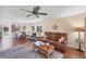 Inviting living room with hardwood floors, comfortable leather seating, and a view into the adjacent kitchen and dining area at 6422 Auburn Ave, Bradenton, FL 34207