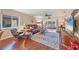 Cozy living room featuring hardwood floors, comfortable leather seating, and a sliding glass door to the backyard at 6422 Auburn Ave, Bradenton, FL 34207