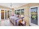Bright sunroom offering water views, tile floors, and access to the outdoor patio at 6422 Auburn Ave, Bradenton, FL 34207