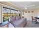 Cozy sunroom overlooking the lake, with tiled floor and comfortable furnishings at 6422 Auburn Ave, Bradenton, FL 34207