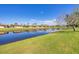 Beautiful waterfront view showcases a serene lake bordered by lush green lawns and charming homes at 6422 Auburn Ave, Bradenton, FL 34207