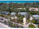 Aerial view of the house in a wooded neighborhood near the beach at 7320 Melaleuca Way, Siesta Key, FL 34242