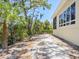 Expansive backyard with lush greenery, shell covered ground, and a tranquil setting at 7320 Melaleuca Way, Siesta Key, FL 34242
