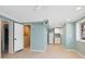 Finished basement space with tile floors, a small kitchenette with white cabinets and a mini-fridge at 7320 Melaleuca Way, Siesta Key, FL 34242