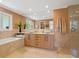 Modern bathroom featuring double sinks, sleek cabinetry, large mirror, and separate shower and tub at 7320 Melaleuca Way, Siesta Key, FL 34242