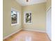 Cozy bedroom with hardwood floors and bright windows offering natural light at 7320 Melaleuca Way, Siesta Key, FL 34242