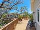 Large wooden deck with a view of the surrounding houses and trees at 7320 Melaleuca Way, Siesta Key, FL 34242