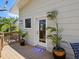 Outdoor deck with door, plants, and a view of trees at 7320 Melaleuca Way, Siesta Key, FL 34242