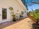 Outdoor deck area with potted plants, a seating area, and wooden railings offering serene outdoor relaxation at 7320 Melaleuca Way, Siesta Key, FL 34242