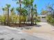 Lovely home with tropical landscaping, a large driveway, and mature trees at 7320 Melaleuca Way, Siesta Key, FL 34242
