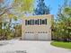 Two-story building with a pair of garages and plenty of trees at 7320 Melaleuca Way, Siesta Key, FL 34242