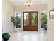 Bright foyer featuring double entry doors with side windows and tiled flooring at 7320 Melaleuca Way, Siesta Key, FL 34242
