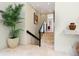 Hallway featuring tile floors, stairs, and a large plant at 7320 Melaleuca Way, Siesta Key, FL 34242