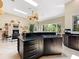 Open kitchen layout with black countertops, an island and stainless steel appliances at 7320 Melaleuca Way, Siesta Key, FL 34242