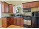 Updated kitchen with stainless steel appliances, wooden cabinets, and granite countertops at 7320 Melaleuca Way, Siesta Key, FL 34242