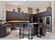 Modern kitchen featuring a bar area, stainless steel appliances, and ample cabinet space at 7320 Melaleuca Way, Siesta Key, FL 34242