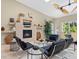 Stylish living room featuring a fireplace, modern furniture and large windows at 7320 Melaleuca Way, Siesta Key, FL 34242