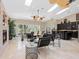 Bright living room with fireplace, travertine floors, skylights, and wet bar at 7320 Melaleuca Way, Siesta Key, FL 34242