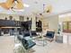Open-concept design living room with fireplace, kitchen and comfortable seating arrangement at 7320 Melaleuca Way, Siesta Key, FL 34242