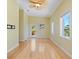 Bright living room with neutral walls, wood floors, and a decorative ceiling fan at 7320 Melaleuca Way, Siesta Key, FL 34242