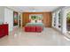 Bright main bedroom featuring large windows, built-in wardrobes, and an ensuite bathroom at 7320 Melaleuca Way, Siesta Key, FL 34242