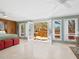 Main bedroom with access to private deck and views of lush nature at 7320 Melaleuca Way, Siesta Key, FL 34242