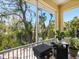 Screened porch with grill and view of lush landscaping at 7320 Melaleuca Way, Siesta Key, FL 34242