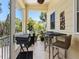 Outdoor porch with bar height table and chairs, grill and decor at 7320 Melaleuca Way, Siesta Key, FL 34242