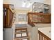 View of split level room and stairs with wood railings and shelving units at 7320 Melaleuca Way, Siesta Key, FL 34242