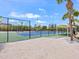 Well-maintained tennis court with blue and green surface and covered spectator area at 7320 Melaleuca Way, Siesta Key, FL 34242