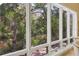A wall of windows offer amazing views of the yard and surrounding landscape at 7320 Melaleuca Way, Siesta Key, FL 34242