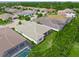 Aerial view of a home showcasing its backyard, mature landscaping, and proximity to neighboring properties at 7717 Sandhill Lake Dr, Sarasota, FL 34241