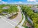 Aerial view of a gated community entrance, showcasing the meticulously landscaped grounds and beautiful homes at 7717 Sandhill Lake Dr, Sarasota, FL 34241