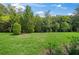 Lush green lawn with an array of trees and foliage, enhancing the property's natural privacy at 7717 Sandhill Lake Dr, Sarasota, FL 34241