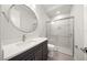 Bathroom with white countertop vanity with dark cabinets and glass enclosed shower at 7717 Sandhill Lake Dr, Sarasota, FL 34241