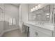 Bathroom features a marble countertop, vanity and a large mirror at 7717 Sandhill Lake Dr, Sarasota, FL 34241