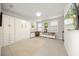 Bonus room with built-in Murphy bed, cabinetry, a desk, and a wall-mounted television at 7717 Sandhill Lake Dr, Sarasota, FL 34241