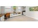 Bonus room with built-in cabinets, a desk and a wall-mounted television at 7717 Sandhill Lake Dr, Sarasota, FL 34241