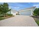 Stunning home exterior with a wide driveway, beautiful landscaping, and a well-maintained facade at 7717 Sandhill Lake Dr, Sarasota, FL 34241