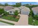 A beautifully landscaped single-Gathering home boasts a paver driveway and a well-maintained lawn at 7717 Sandhill Lake Dr, Sarasota, FL 34241