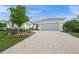 Charming home exterior with manicured landscaping, a spacious driveway, and a welcoming entrance at 7717 Sandhill Lake Dr, Sarasota, FL 34241
