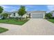 Attractive home with lush landscaping, a paved driveway, and a well-maintained facade at 7717 Sandhill Lake Dr, Sarasota, FL 34241