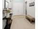 The foyer has a decorative table with flowers, a bench, and tile flooring at 7717 Sandhill Lake Dr, Sarasota, FL 34241