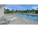 Inviting hot tub area with comfortable lounge chairs, lush tropical plants, and a relaxing atmosphere at 7717 Sandhill Lake Dr, Sarasota, FL 34241