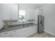 Well-lit kitchen featuring white cabinetry, stainless steel appliances, and stylish countertops at 7717 Sandhill Lake Dr, Sarasota, FL 34241