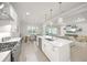 Open concept kitchen with white cabinets, a center island, and stainless steel appliances at 7717 Sandhill Lake Dr, Sarasota, FL 34241