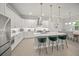 Bright kitchen boasts white cabinets, stainless appliances, and center island with seating at 7717 Sandhill Lake Dr, Sarasota, FL 34241