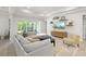 Open concept living room with sliding glass doors and built-in shelving at 7717 Sandhill Lake Dr, Sarasota, FL 34241